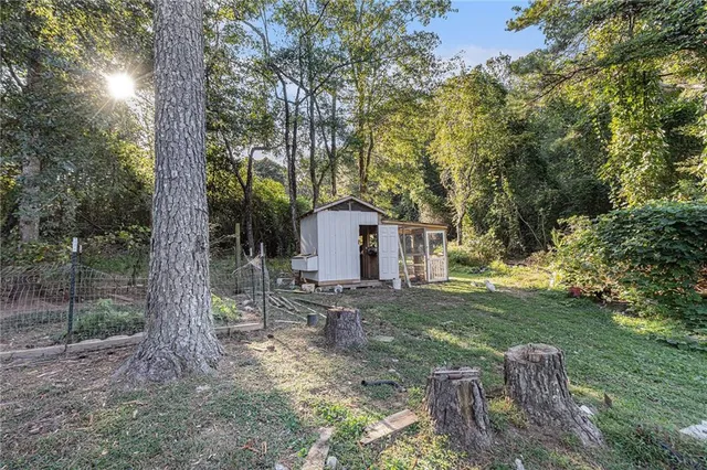 a view of a house with backyard and a tree