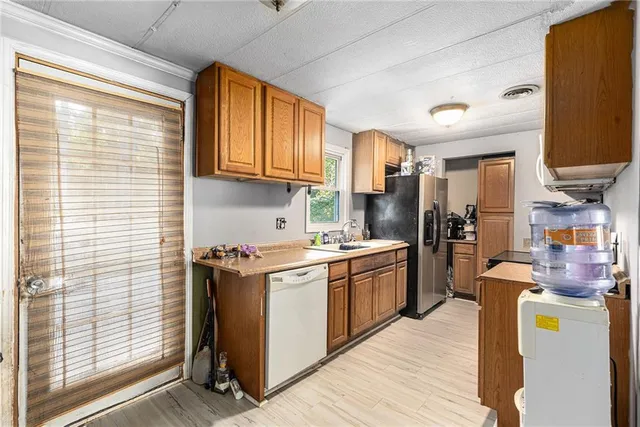 a kitchen with stainless steel appliances granite countertop a stove and a refrigerator