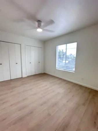 an empty room with windows and closet