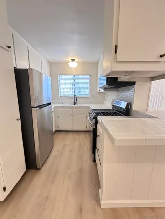 a kitchen with a refrigerator a sink and dishwasher