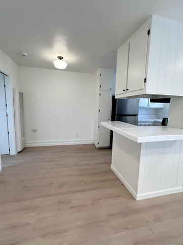 a kitchen with stainless steel appliances white cabinets and a sink