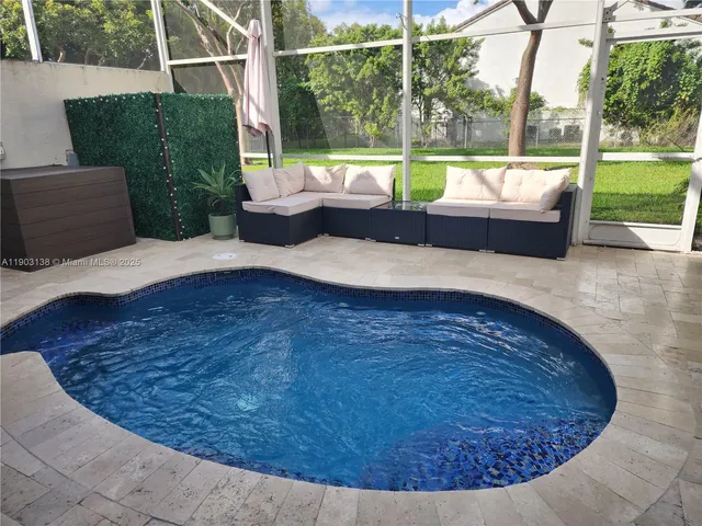 a living room with couch and a large window