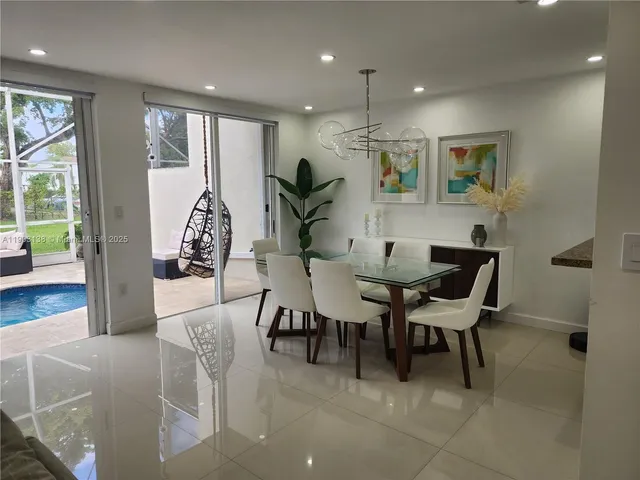 a view of a dining room with furniture and a potted plant