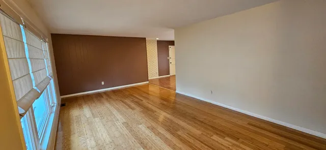 a view of walk in closet with wooden floor