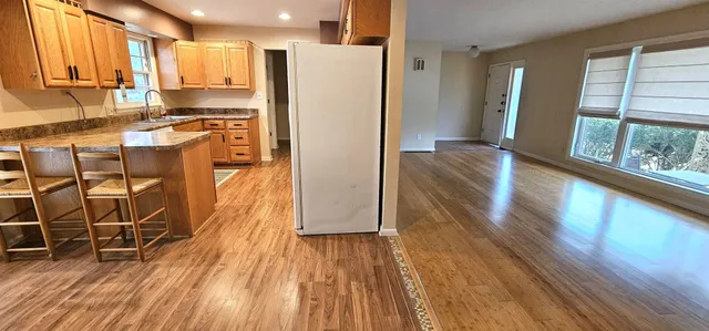 a kitchen with granite countertop wooden floors and stainless steel appliances
