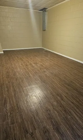 a view of a room with wooden floor