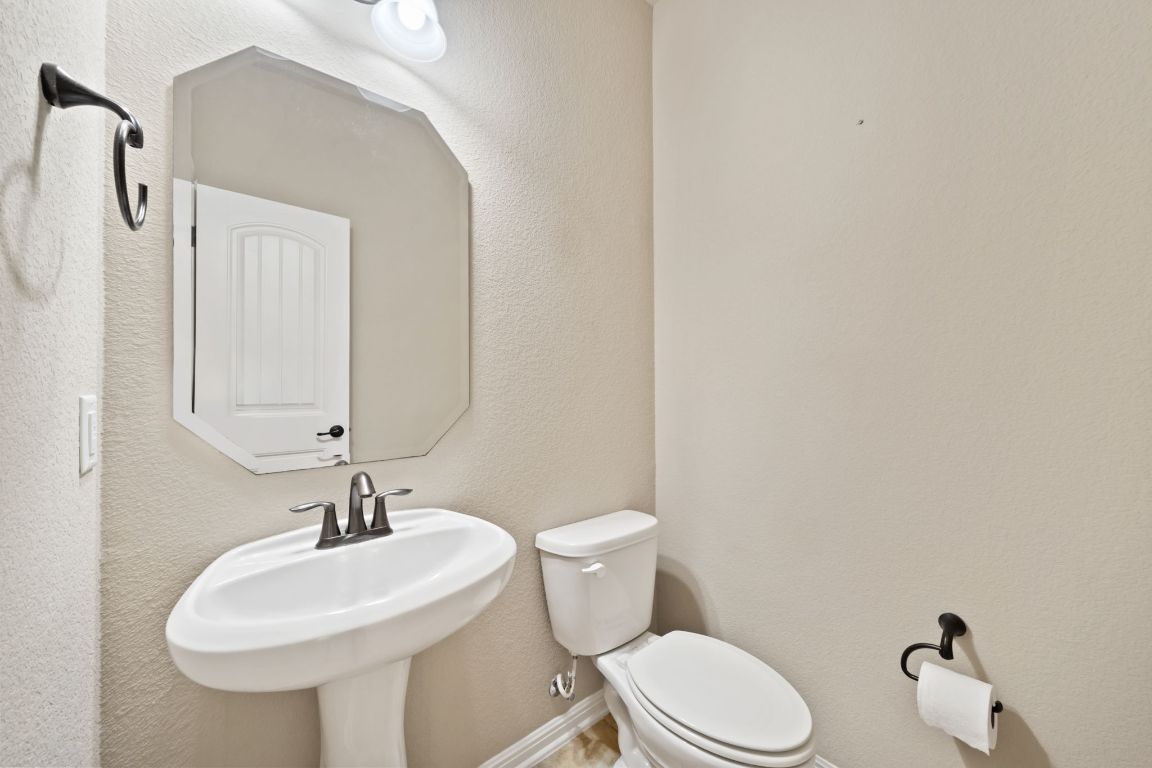 209 Rock Vista Run Austin, TX 78737 - Photo 12 of 40 a bathroom with a sink toilet and mirror