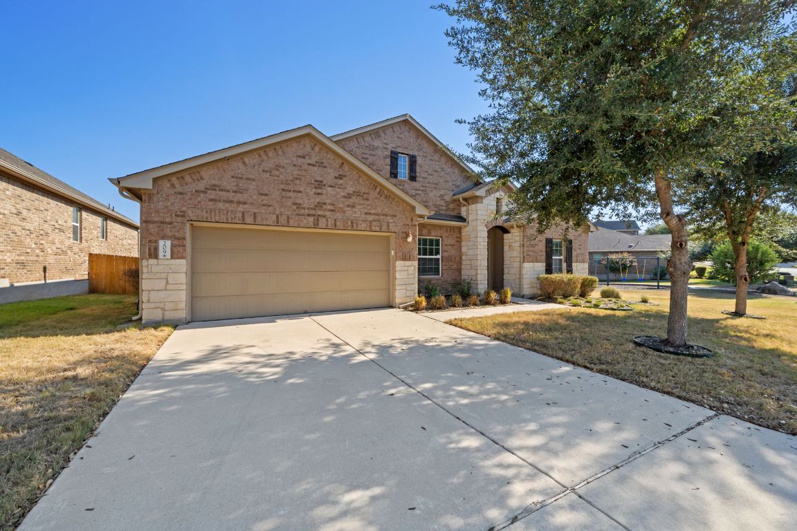 209 Rock Vista Run Austin, TX 78737 - Photo 13 of 40 a front view of a house with a yard and garage