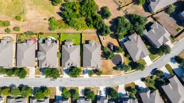 a bathroom with a granite countertop double vanity sink and a mirror