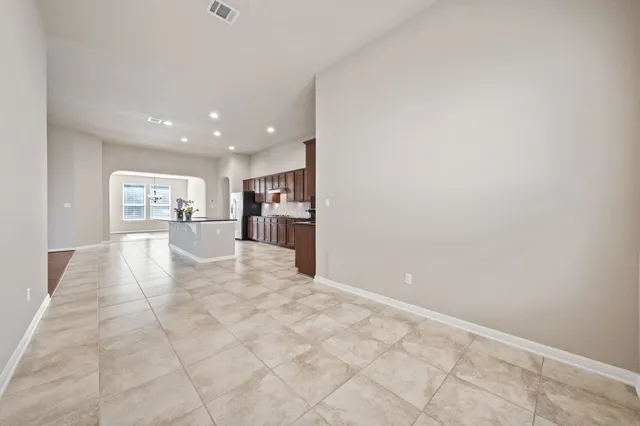 a view of a roof deck with wooden fence and a floor to ceiling window