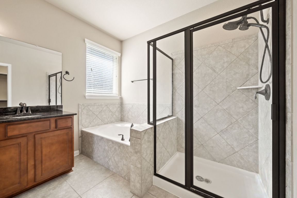 209 Rock Vista Run Austin, TX 78737 - Photo 26 of 40 a bathroom with a bathtub and a shower
