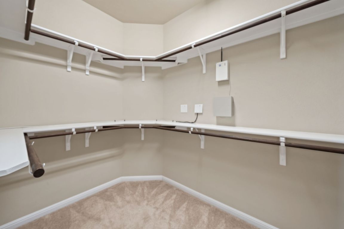 209 Rock Vista Run Austin, TX 78737 - Photo 27 of 40 a view of a room with racks on the wall