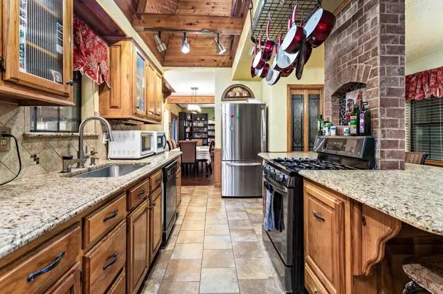 a kitchen with stainless steel appliances granite countertop lots of counter top space