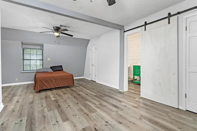 a bedroom with a bed and window