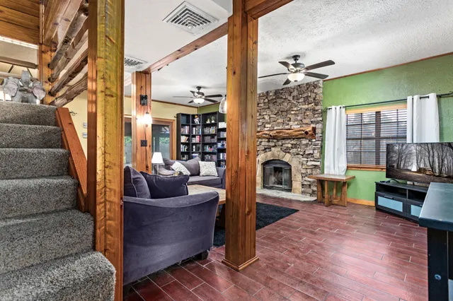 a living room with furniture and a fireplace