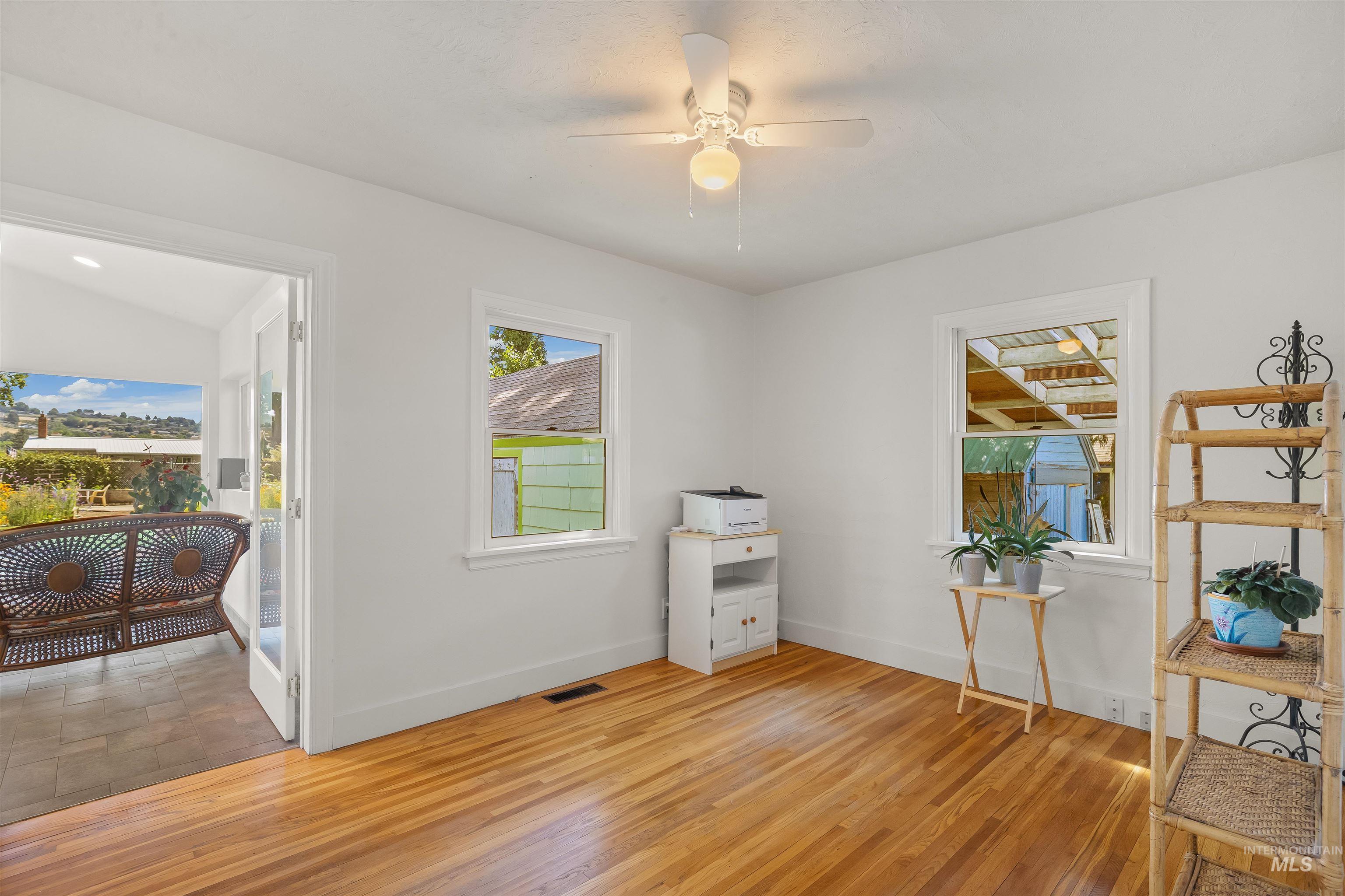 924 N Street Lewiston, ID 83501 - Photo 24 of 46 Bright interior room featuring wood-finish flooring, white walls, and a ceiling fan