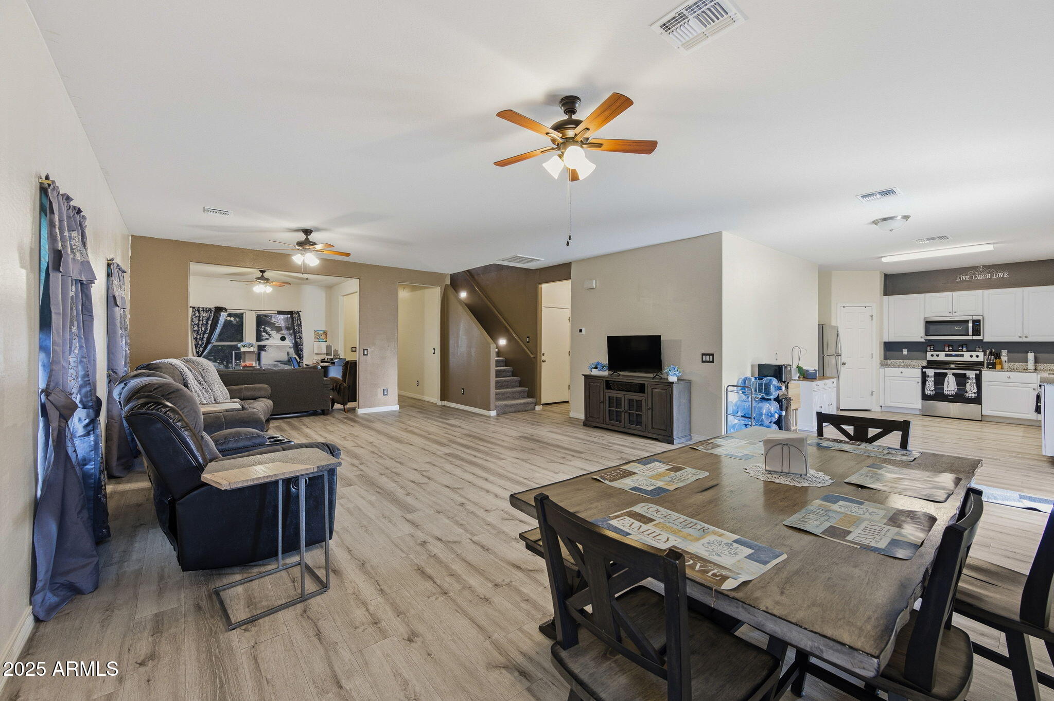 45433 West Sandhill Road Maricopa, AZ 85139 - Photo 11 of 32 a view of a dining room with furniture and wooden floor