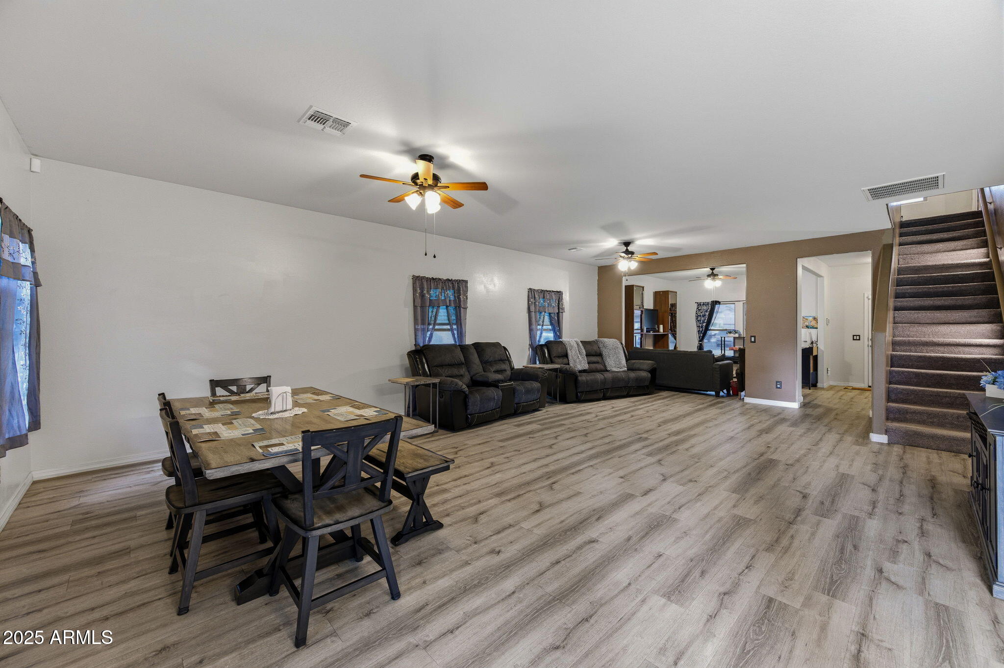 45433 West Sandhill Road Maricopa, AZ 85139 - Photo 12 of 32 a view of a dining room with furniture and wooden floor