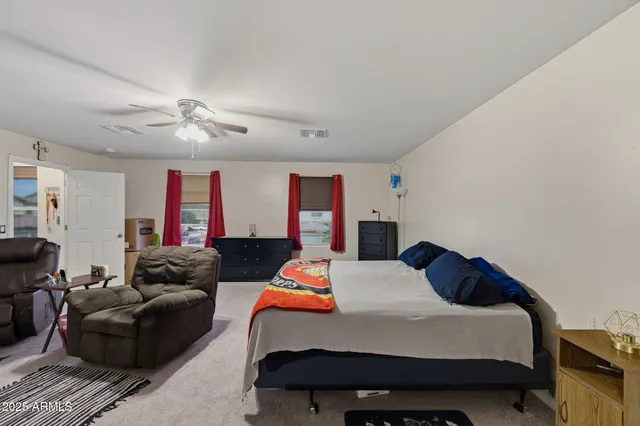 a bedroom with a bed couch and window