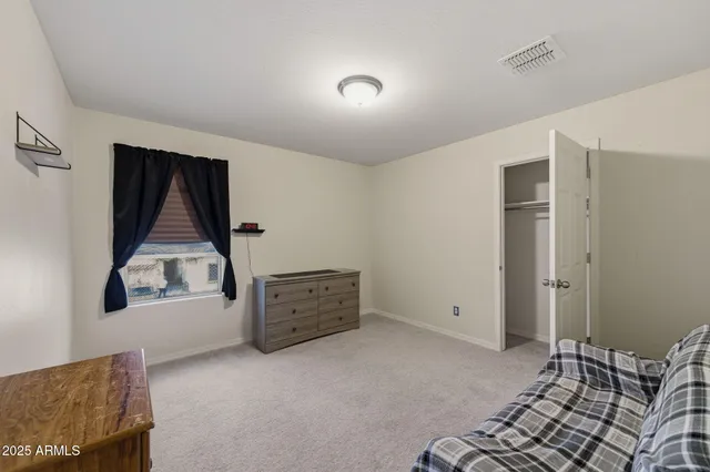 a spacious bedroom with a bed and a couch