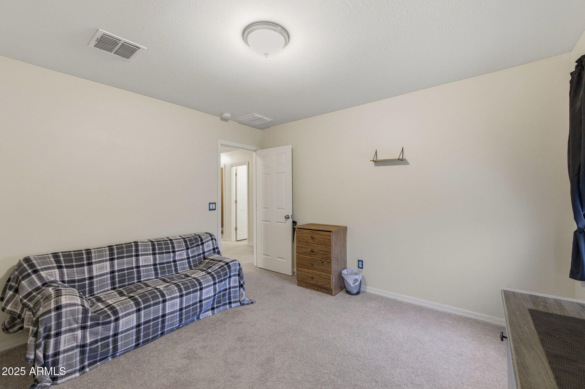 45433 West Sandhill Road Maricopa, AZ 85139 - Photo 20 of 32 a spacious bedroom with a bed and a couch