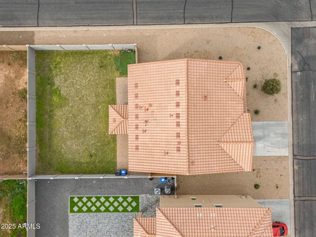 an aerial view of a house with swimming pool lawn chairs and yard