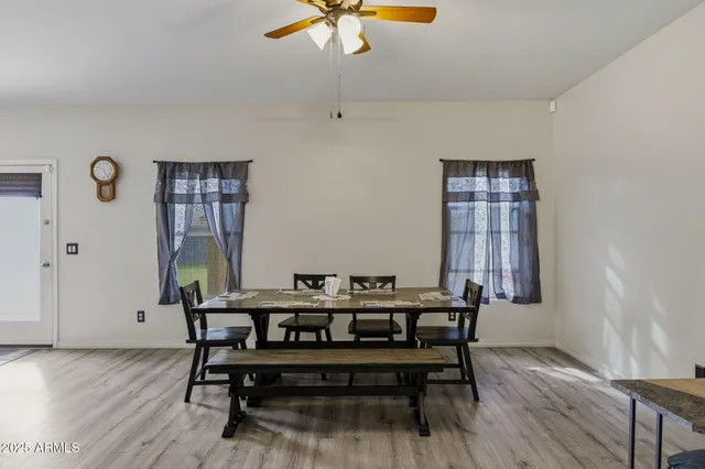 a view of a dining room with furniture and chandelier