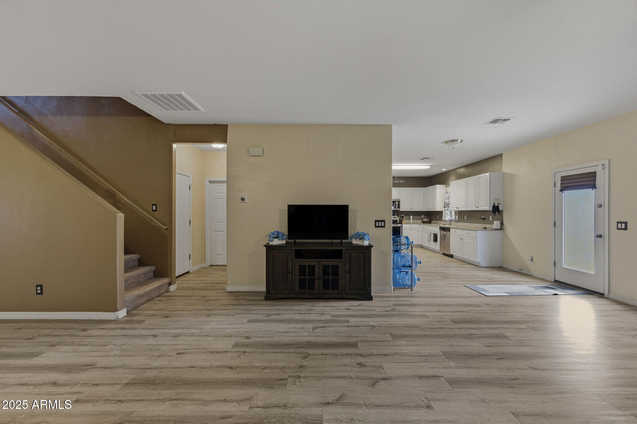 45433 West Sandhill Road Maricopa, AZ 85139 - Photo 10 of 32 a living room with stainless steel appliances kitchen island granite countertop a refrigerator and a stove top oven