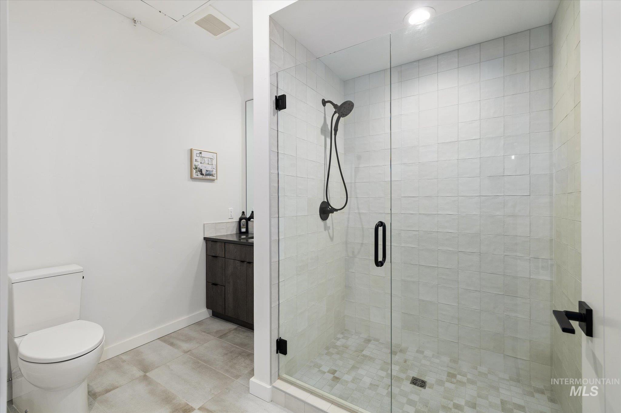 3850 East Haystack Street, Unit 302 Boise, ID 83716 - Photo 18 of 50 Bathroom featuring vanity, a stall shower, and recessed lighting