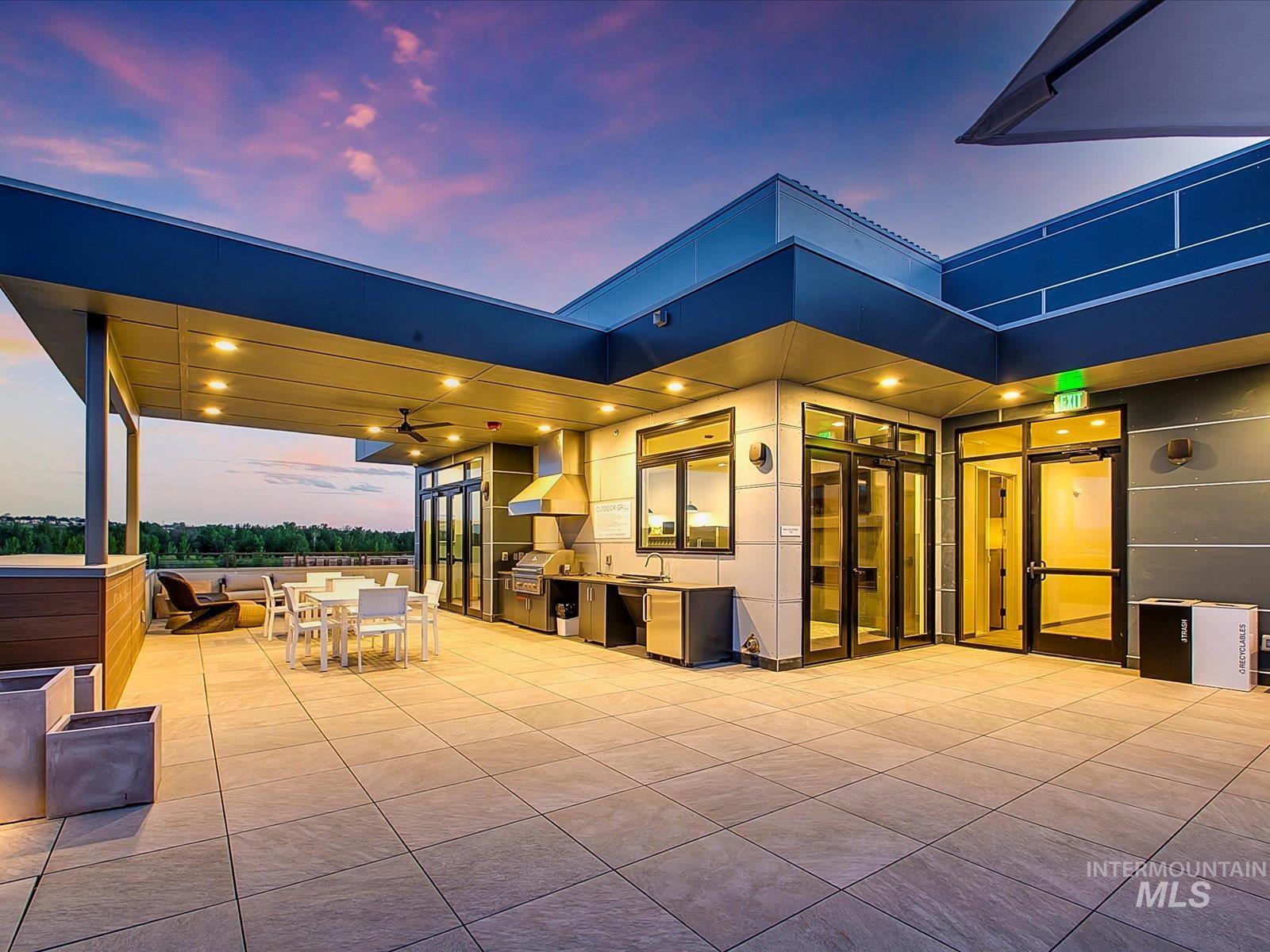 3850 East Haystack Street, Unit 302 Boise, ID 83716 - Photo 45 of 50 Patio terrace at dusk featuring exterior kitchen, a patio, and outdoor dining space