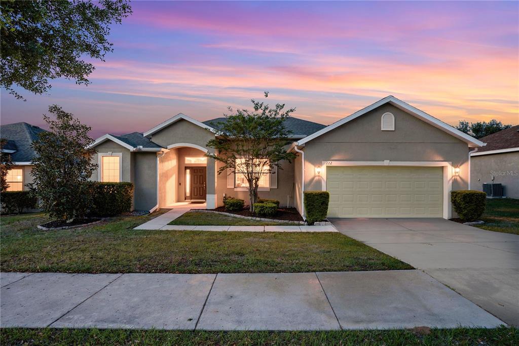 222 Blackstone Creek Road Groveland, FL 34736 - Photo 1 of 49 a front view of a house with a yard and garage