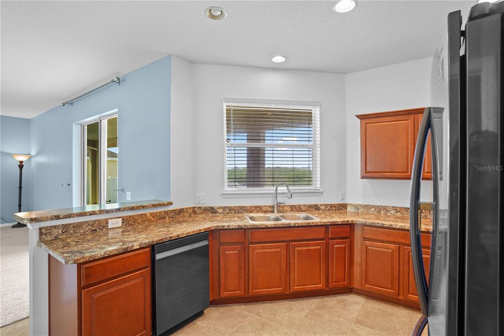 222 Blackstone Creek Road Groveland, FL 34736 - Photo 14 of 49 a bathroom with a granite countertop sink and a mirror