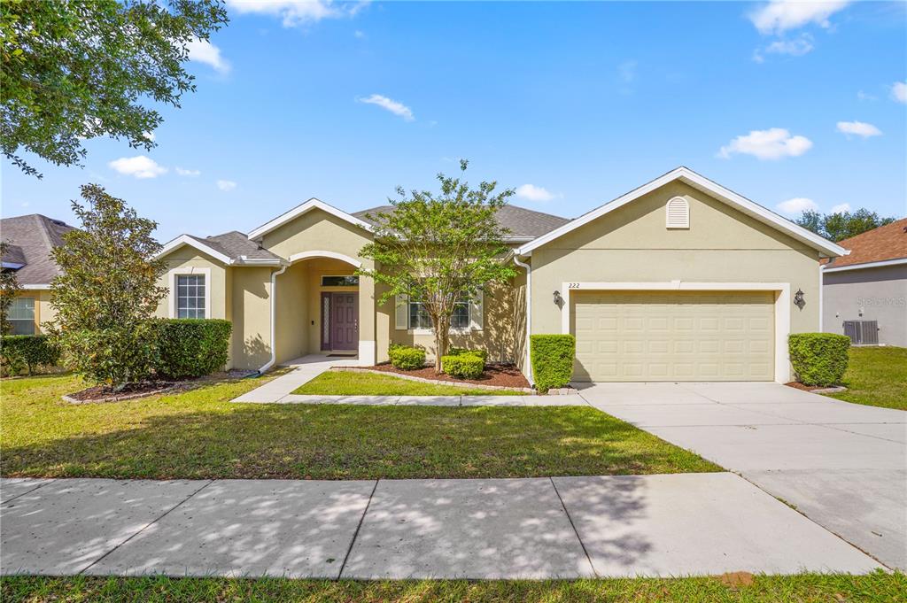 222 Blackstone Creek Road Groveland, FL 34736 - Photo 2 of 49 a front view of a house with a yard and garage