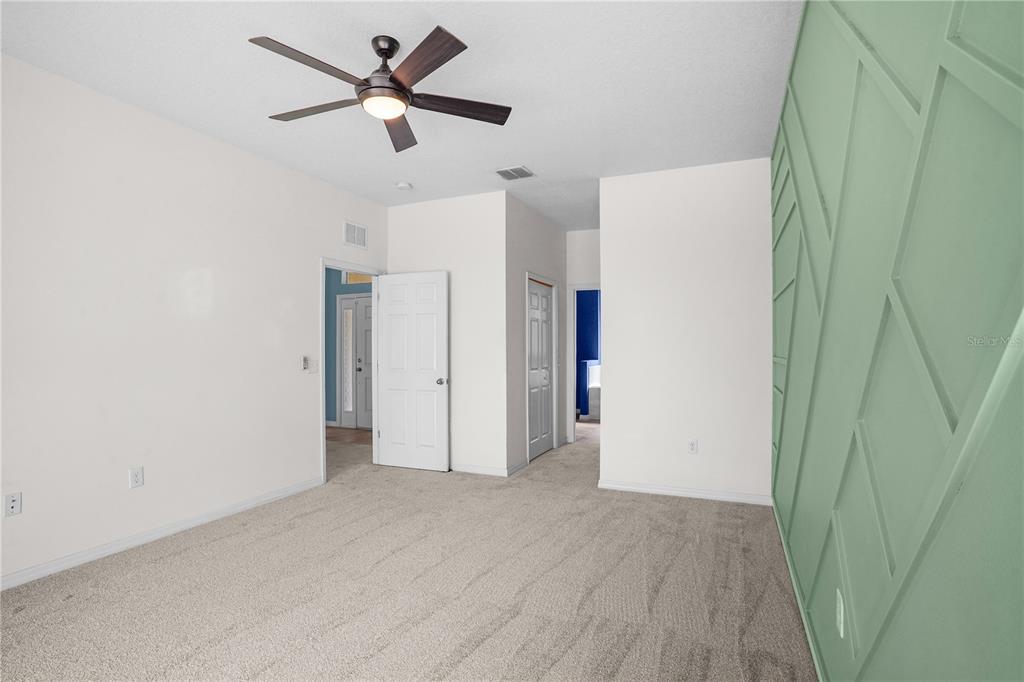 222 Blackstone Creek Road Groveland, FL 34736 - Photo 21 of 49 a view of a livingroom with a ceiling fan & dryer