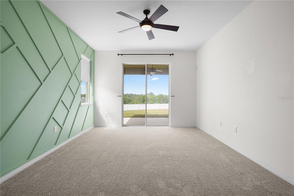 222 Blackstone Creek Road Groveland, FL 34736 - Photo 22 of 49 a view of a room with a window and a ceiling fan
