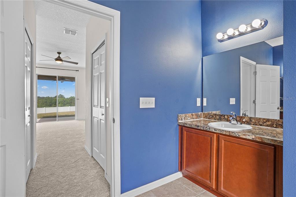 222 Blackstone Creek Road Groveland, FL 34736 - Photo 26 of 49 a en suite bathroom with a sink and a mirror