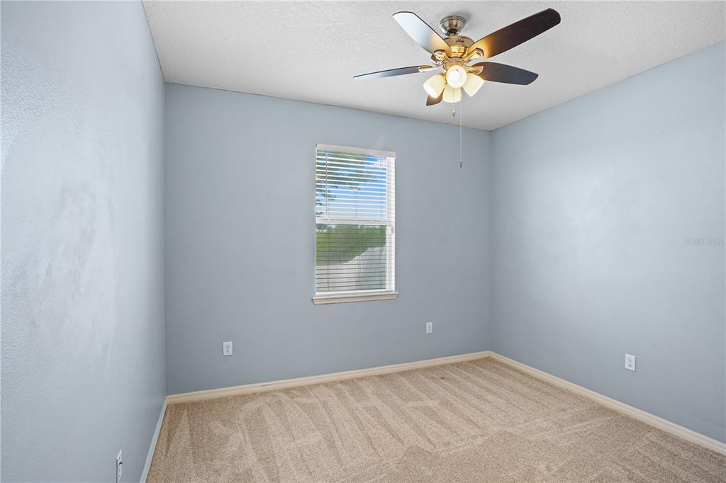 222 Blackstone Creek Road Groveland, FL 34736 - Photo 27 of 49 a view of a workspace with a window and a chandelier fan