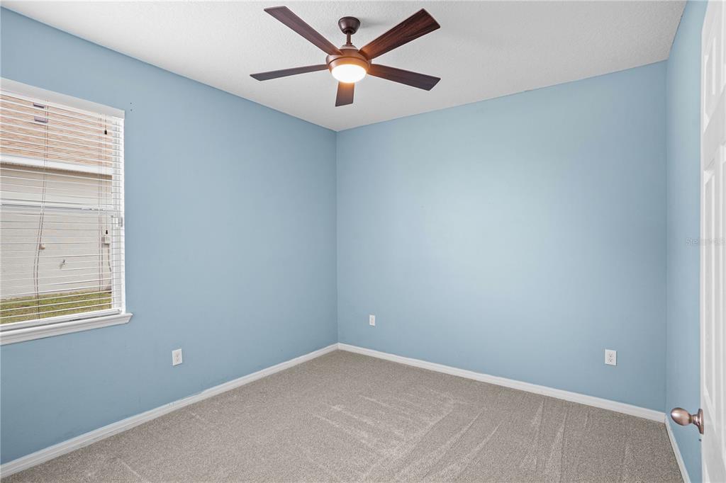 222 Blackstone Creek Road Groveland, FL 34736 - Photo 30 of 49 an empty room with a window and a fan