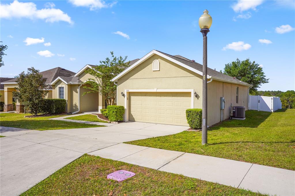 222 Blackstone Creek Road Groveland, FL 34736 - Photo 3 of 49 a front view of a house with garden
