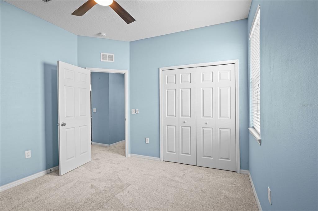 222 Blackstone Creek Road Groveland, FL 34736 - Photo 31 of 49 an empty room with closet and a chandelier fan