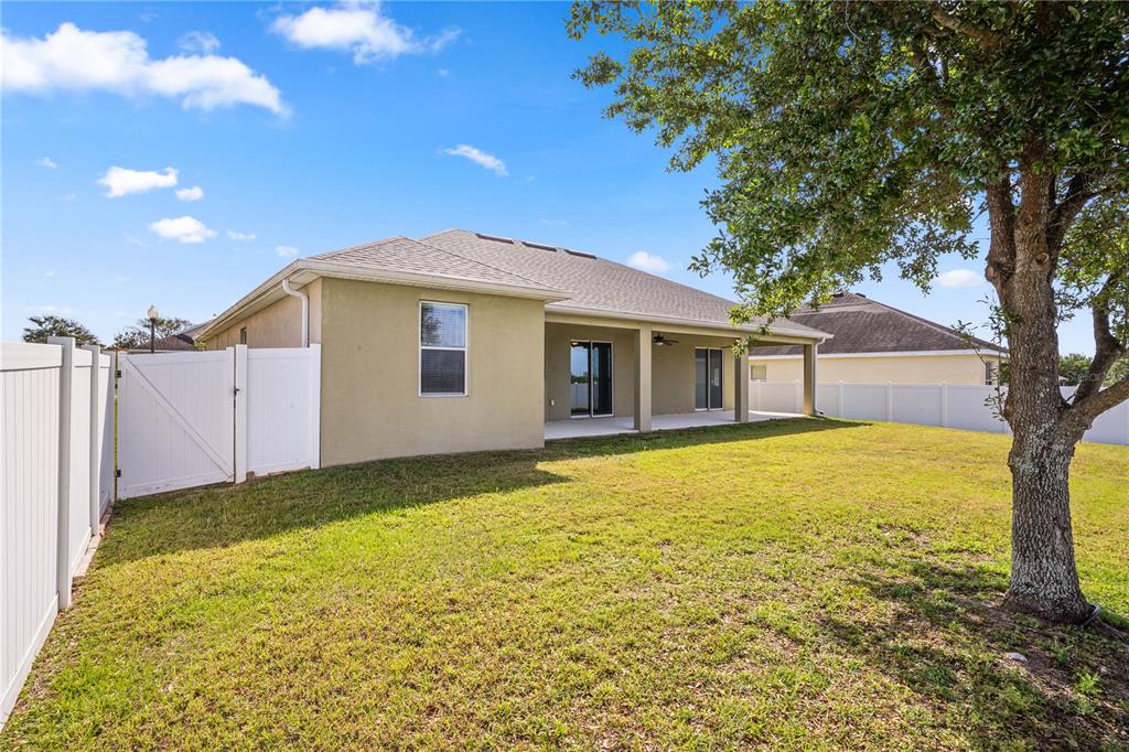222 Blackstone Creek Road Groveland, FL 34736 - Photo 42 of 49 a view of a house with a backyard
