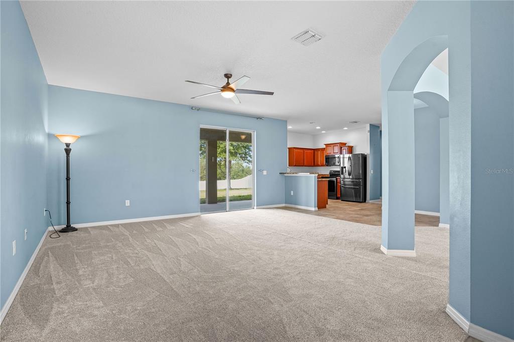 222 Blackstone Creek Road Groveland, FL 34736 - Photo 8 of 49 a view of a livingroom with a flat screen tv