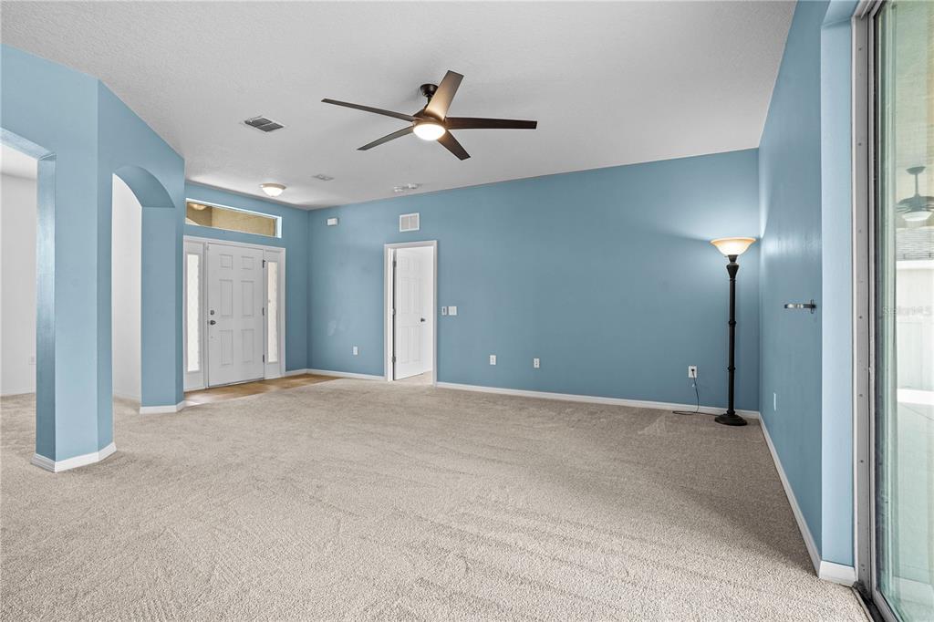 222 Blackstone Creek Road Groveland, FL 34736 - Photo 9 of 49 a view of an empty room with a ceiling fan
