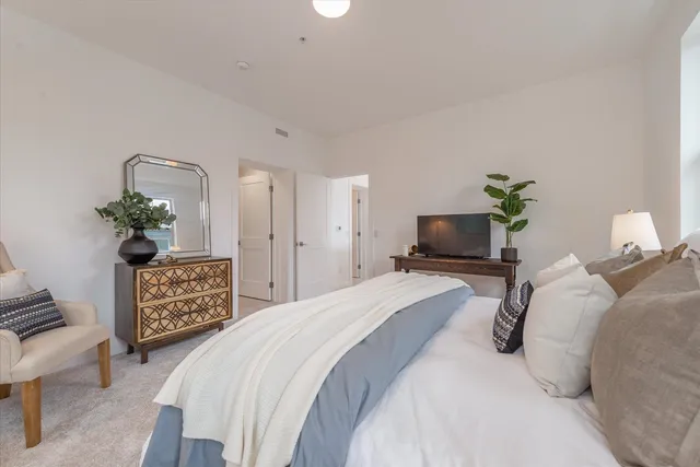 a bedroom with a bed and a couch