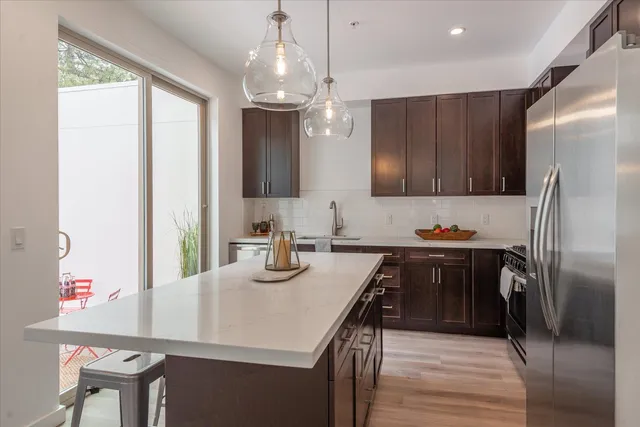 a kitchen with refrigerator cabinets and wooden floor
