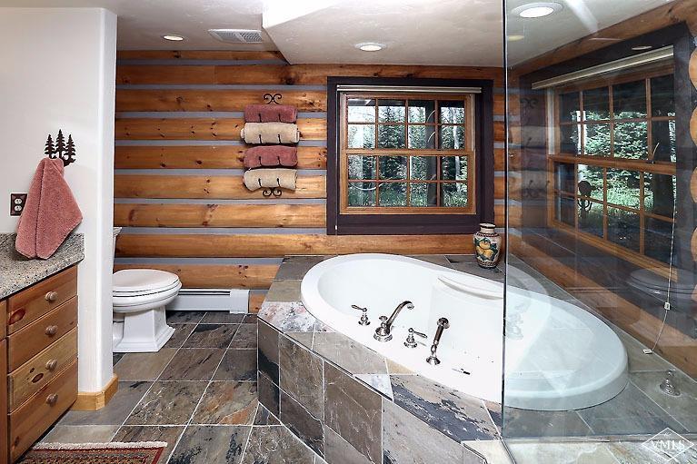 4454 Bellyache Ridge Road Wolcott, CO 81655 - Photo 11 of 25 a bathroom with a bathtub and window