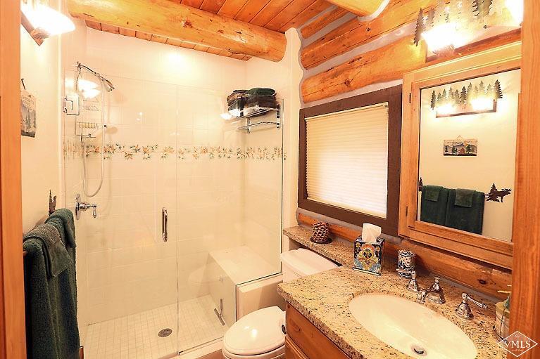 4454 Bellyache Ridge Road Wolcott, CO 81655 - Photo 14 of 25 a bathroom with a granite countertop sink toilet and shower