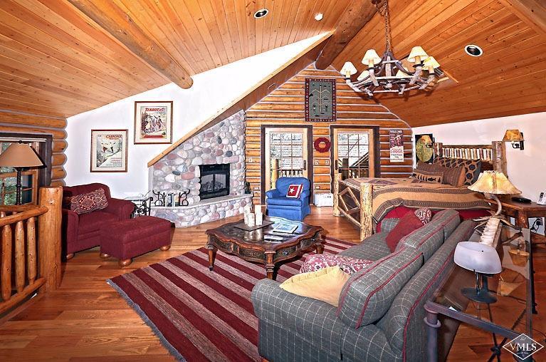 4454 Bellyache Ridge Road Wolcott, CO 81655 - Photo 24 of 25 a living room with furniture a chandelier and a dining table