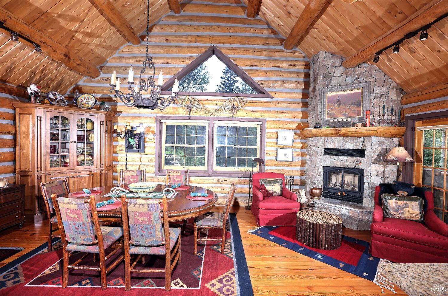 4454 Bellyache Ridge Road Wolcott, CO 81655 - Photo 7 of 25 a view of a dining room with furniture a chandelier and wooden floor