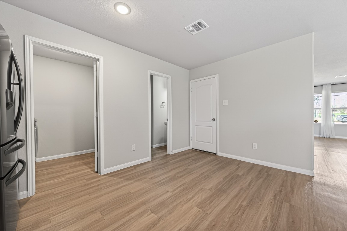 940 21st Street Hempstead, TX 77445 - Photo 15 of 36 an empty room with wooden floor and a window